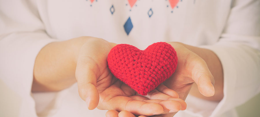 Women wear knit shirt hand holding red heart. Concept of love, hope, happy valentine, healthcare,organ donation,insurance, medical, World heart day, National Organ Donor day,World mental health day.